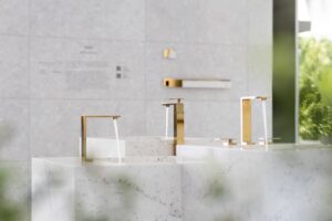gold taps against stone marble surfaces in outdoor bathroom installation by GROHE