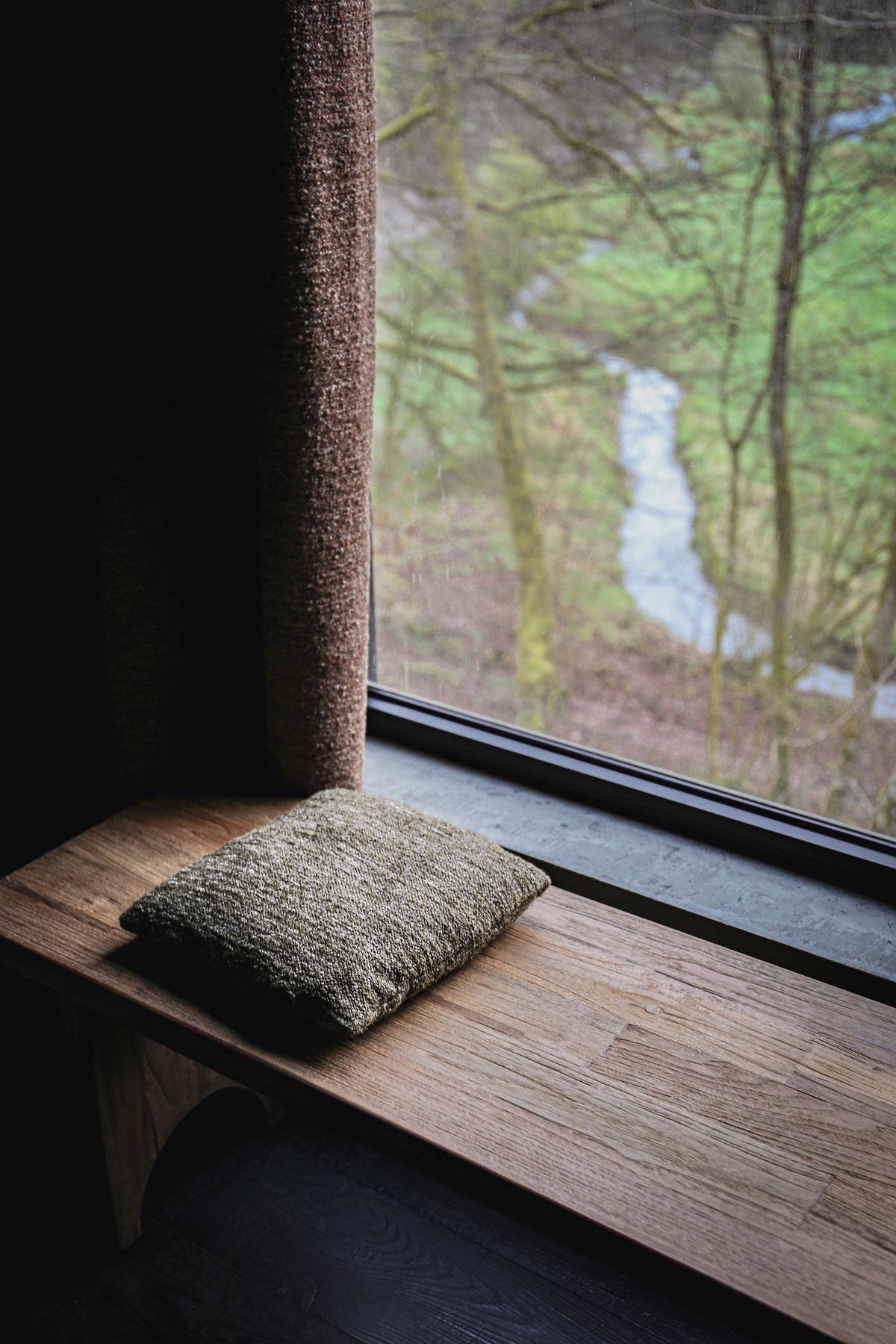 wooden window seat with forest view