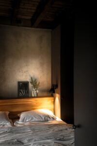 mood lighting and an unmade bed in a cabin in Hillview Resort