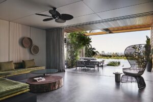 low level seating below a ceiling fan and looking across to terrace and lagoon