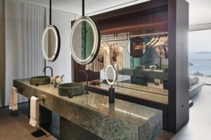 double bathroom vanity with suspended mirrors against dividing dressing room space