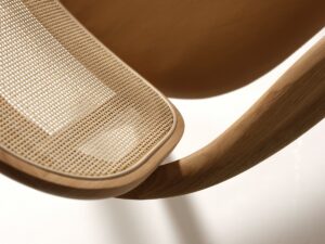detail of Barricane chair with wicker and curved wood