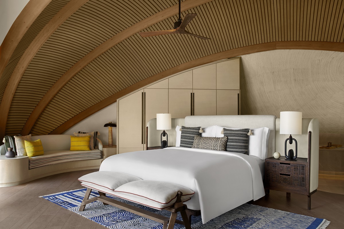 A two-bedroom overwater villa showcasing the signature curved ceilings and natural materials