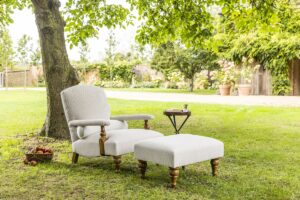 chair and footstool under a tree in the garden