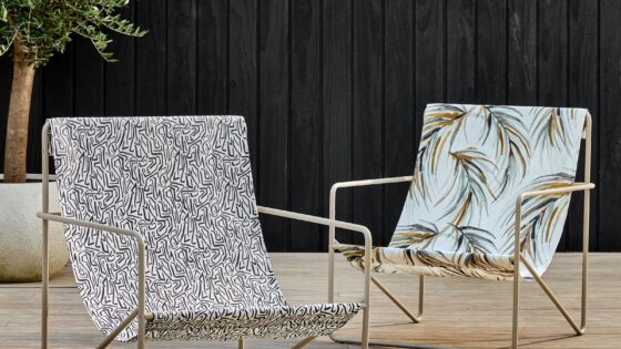 metal deck chairs on wooden deck covered in Harlequin outdoor fabric