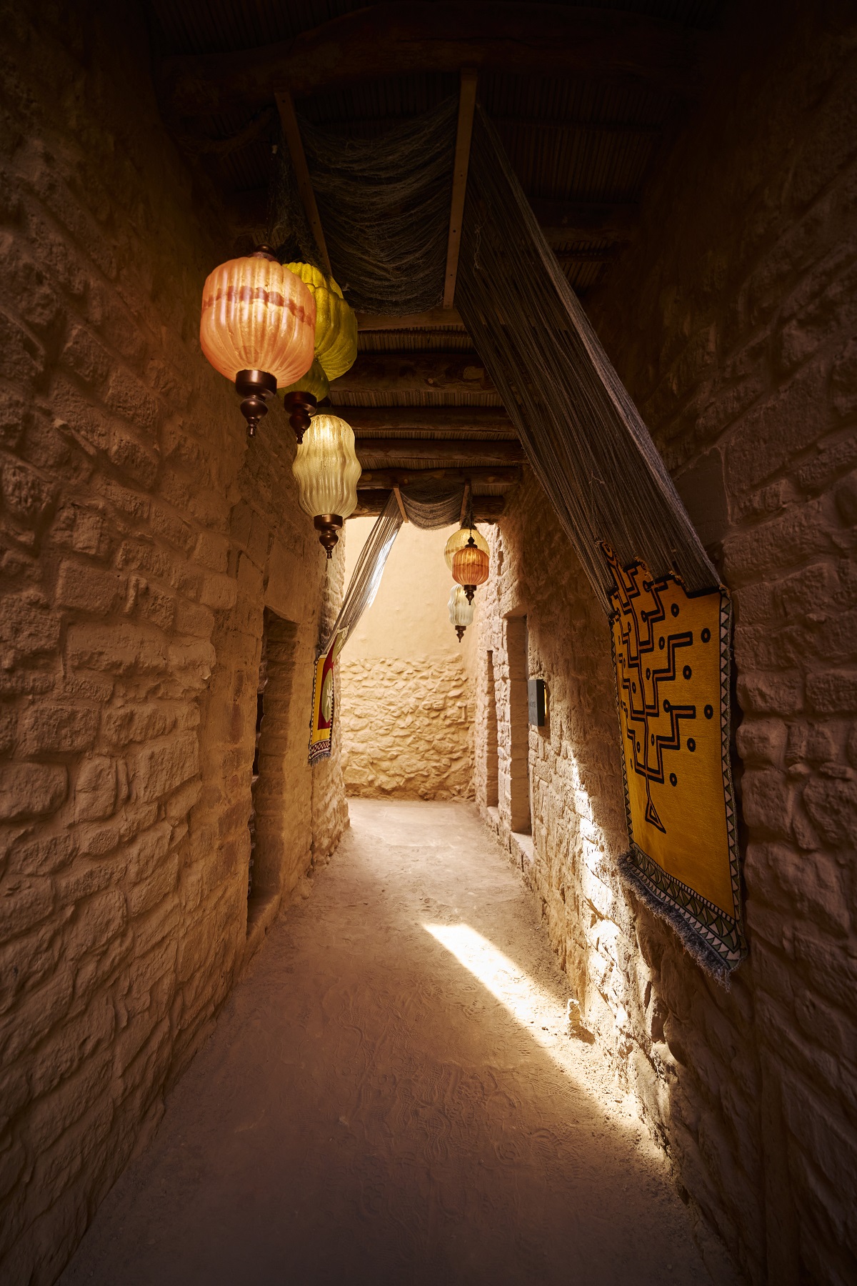 lanterns and tapestry in corridor between rooms at Dar Tantara