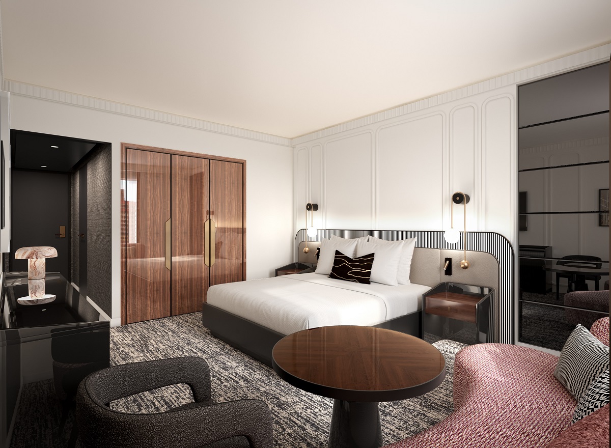 guestroom with black and wood surfaces, patterned carpet and pink couch