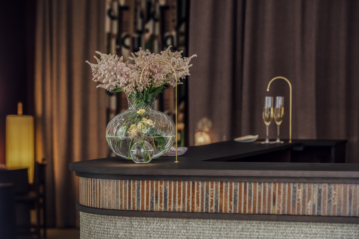 detail of reception with tiles and textures, lighting and flowers