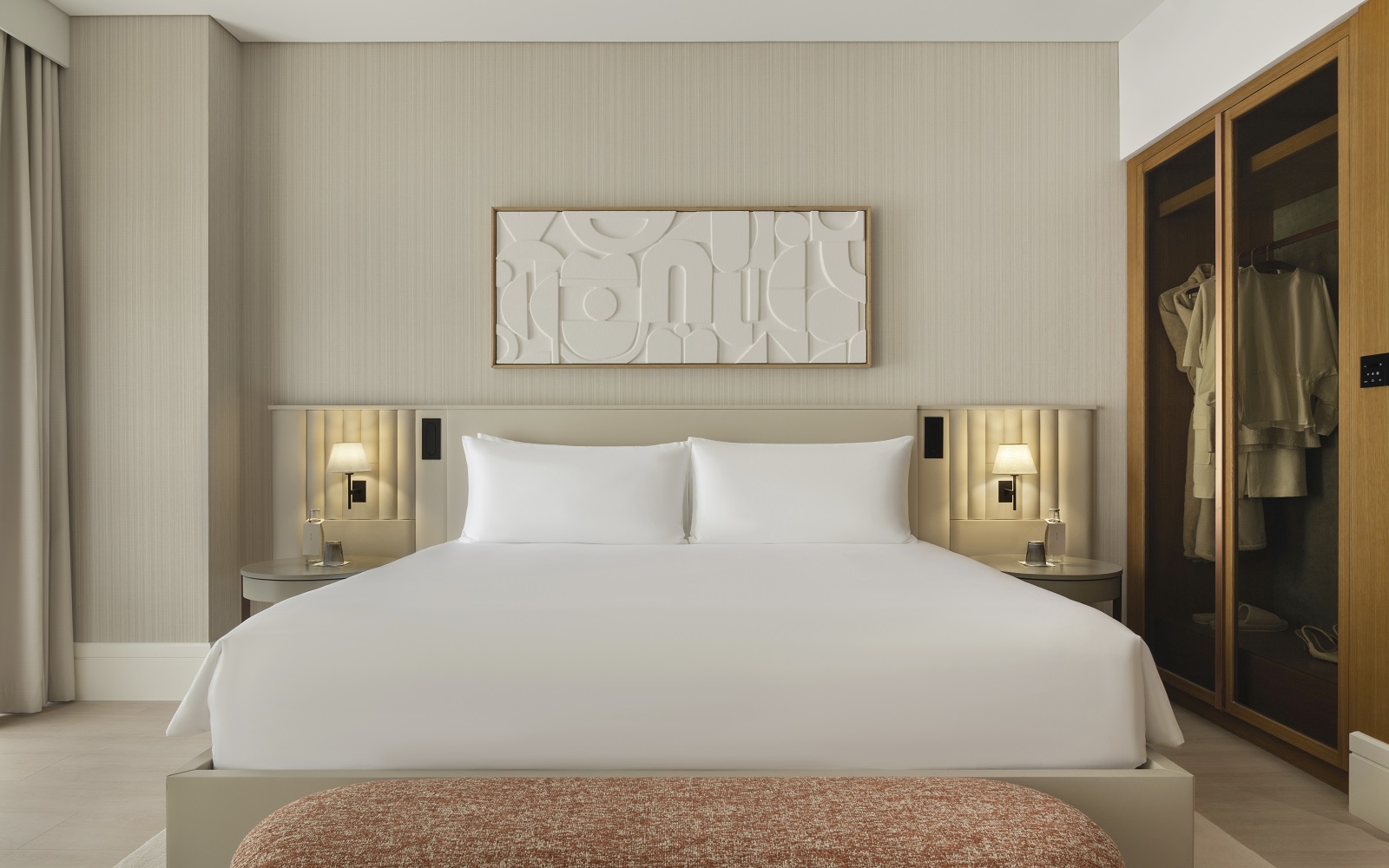 cream surfaces, white bed linen and white art on cream wall in Delano Dubai