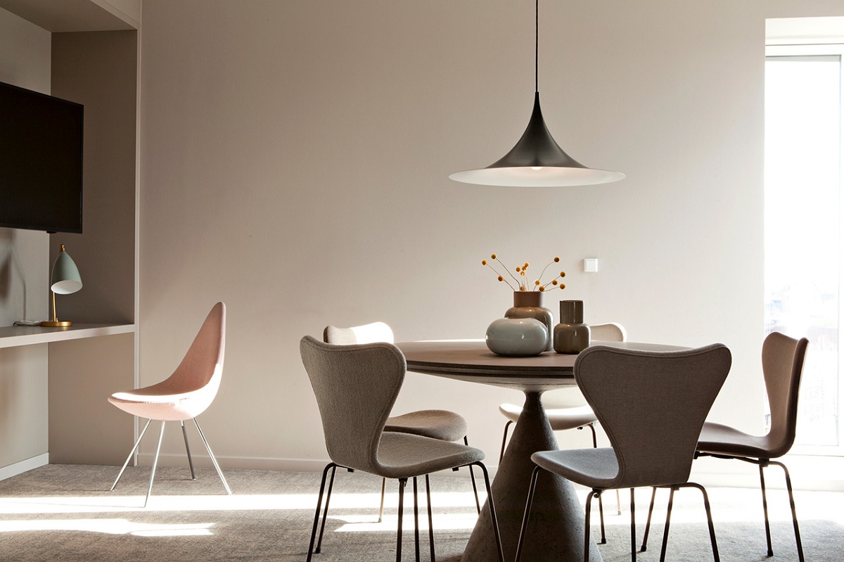 table and chair with central light and curated ceramics in Hotel Odeon