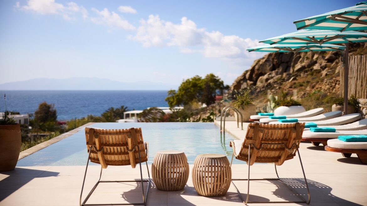 deckchairs and umbrellas by pool with seaview at Nammos Mykonos