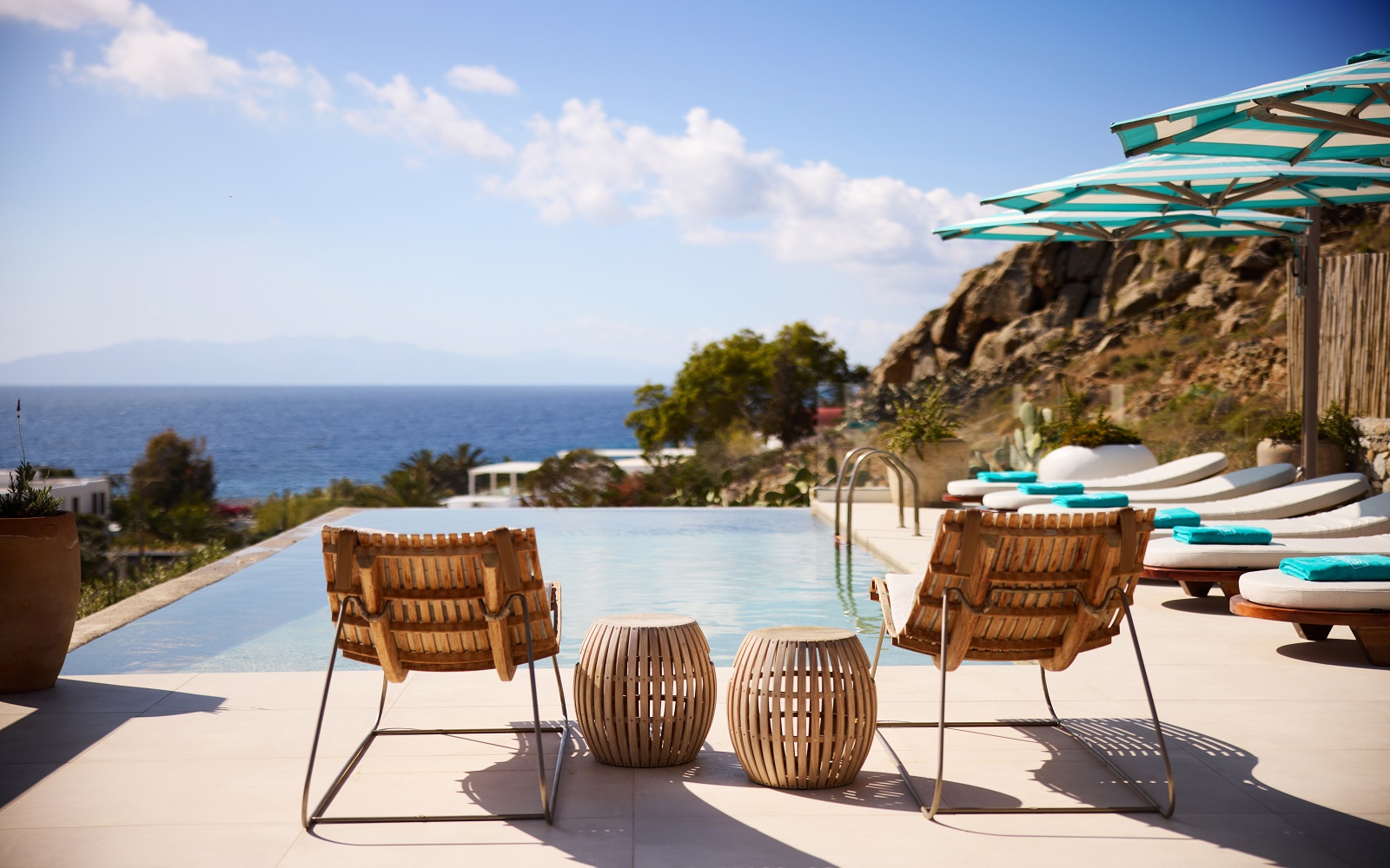 deckchairs and umbrellas by pool with seaview at Nammos Mykonos