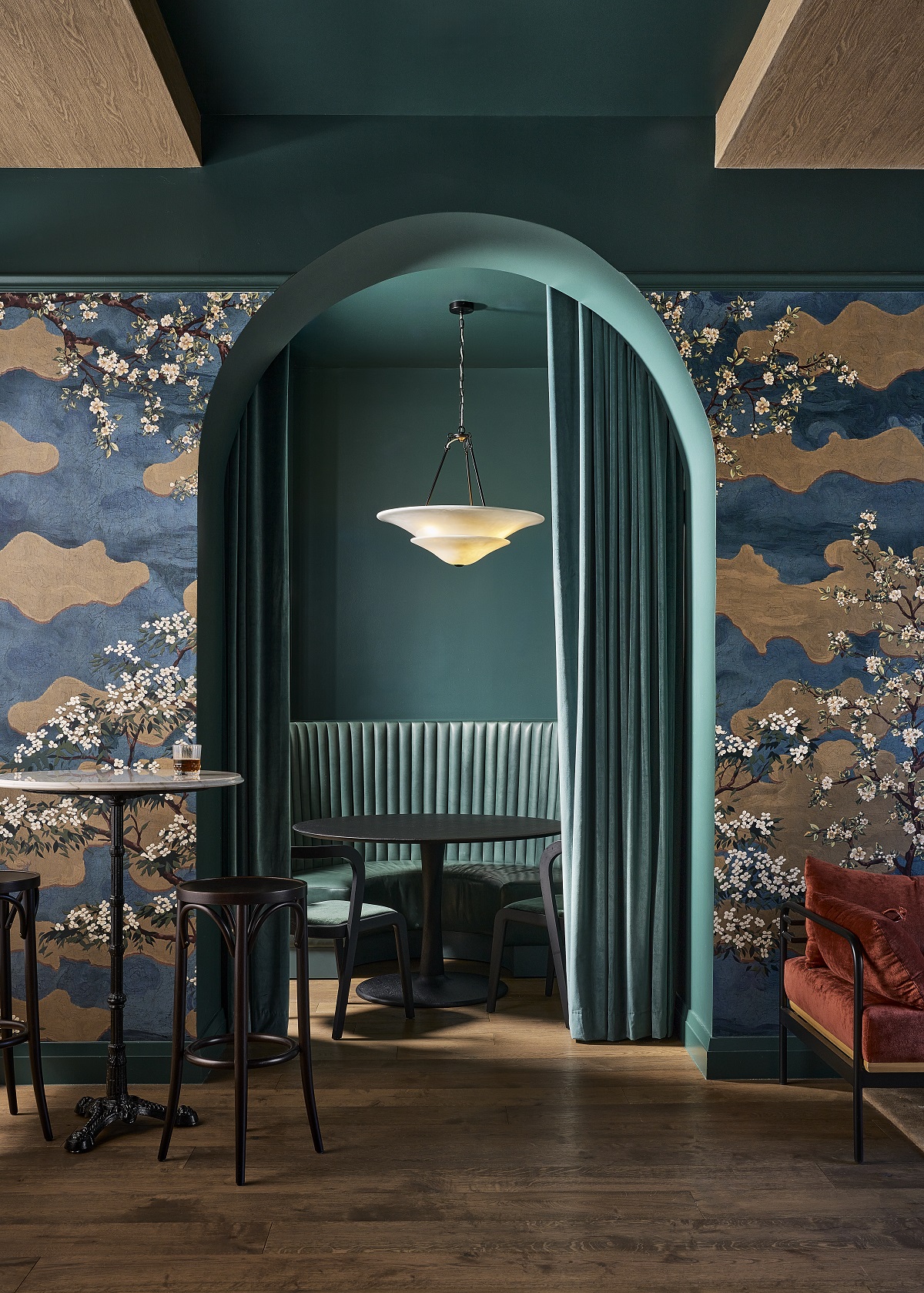 patterned blue wallpaper and arched blue entrance at Hotel Vesper