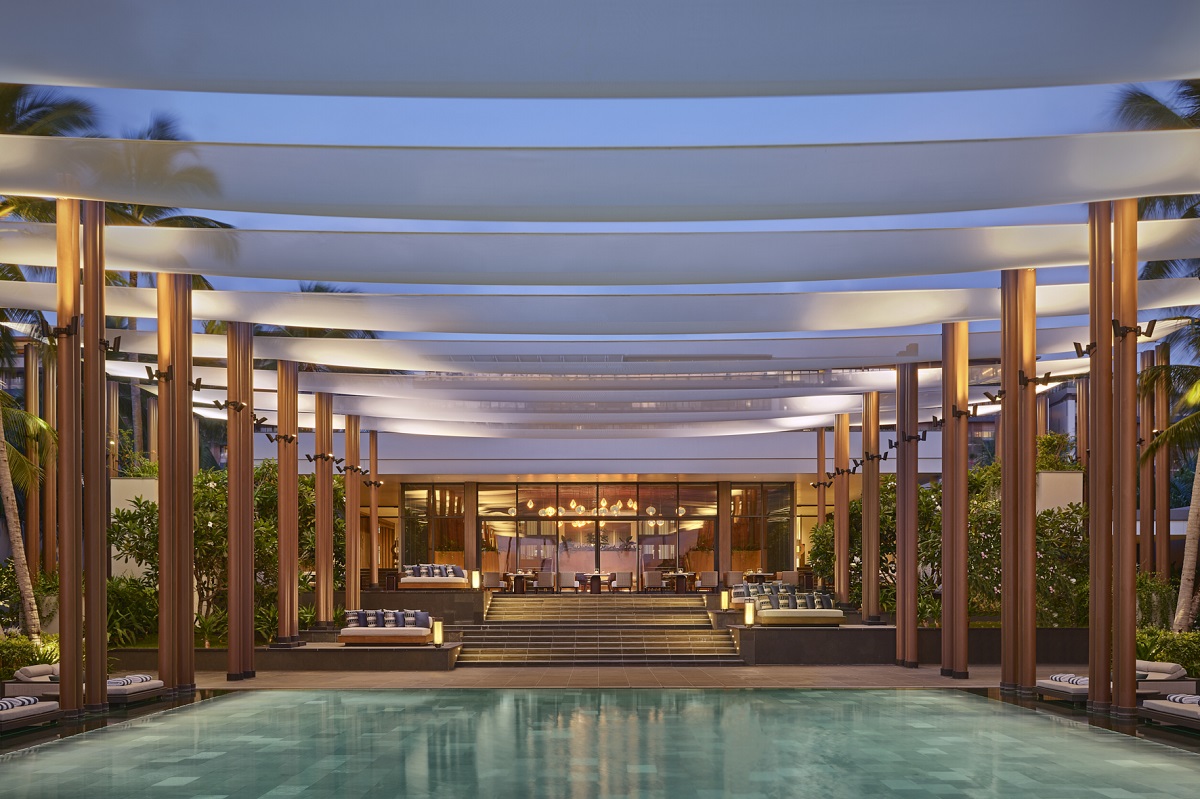 main pool flanked by pillars with drapes overhead