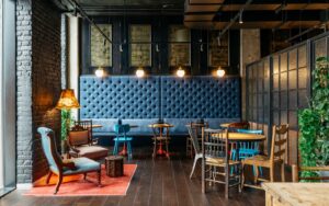 blue banquette and eclectic wooden chairs in Ruby Molly Dublin
