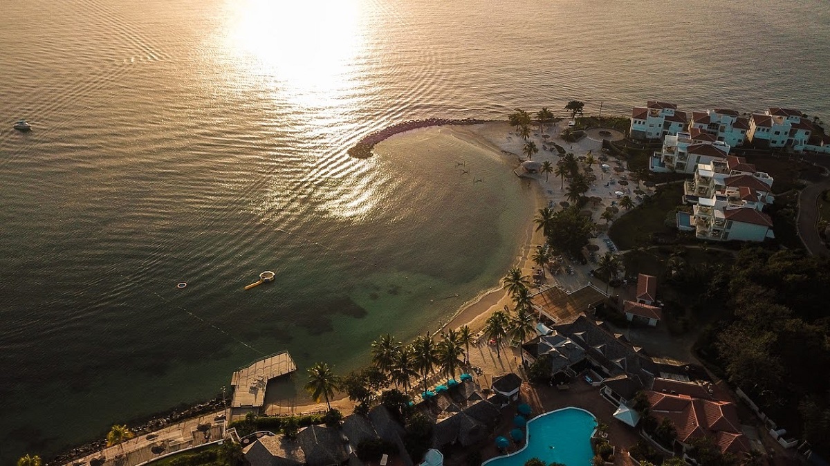 aerial view over Saint Lucia’s Windjammer Landing Villa Beach Resort at sunset