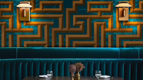 blue velvet banquette with blue and gold optic tropicwallpaper