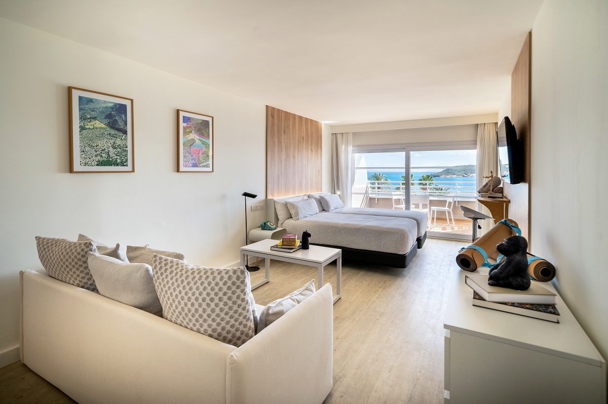 loft style hotel guestroom in cream and white with seaview 