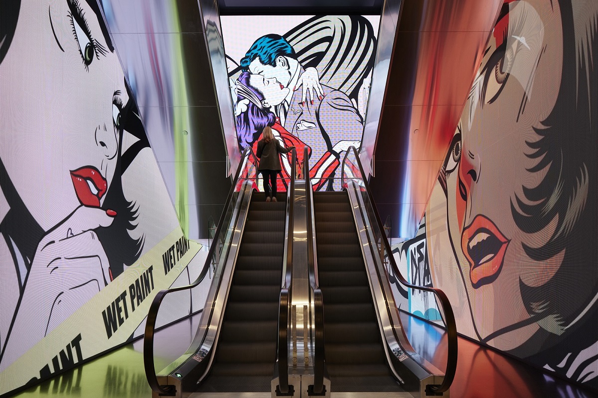 graffitied wall and escalator leading up into art’otel London Hoxton