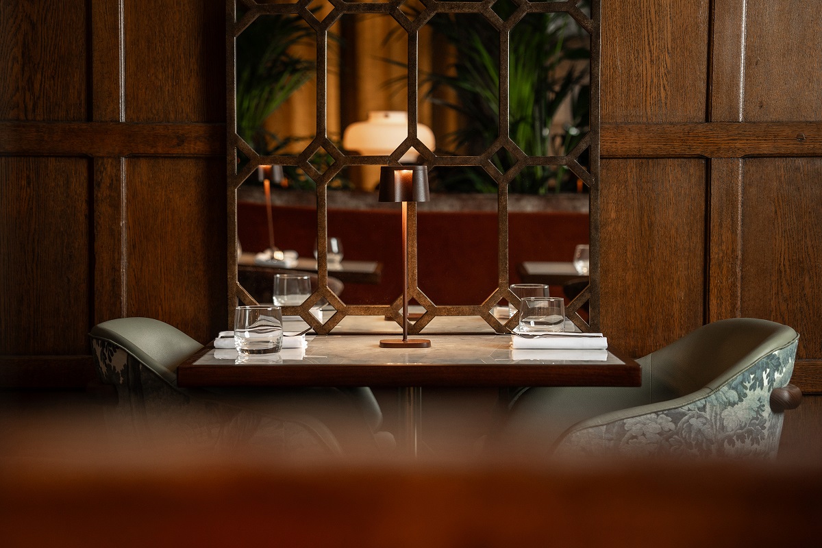 wooden panelling with mirror alongside table in restaurant