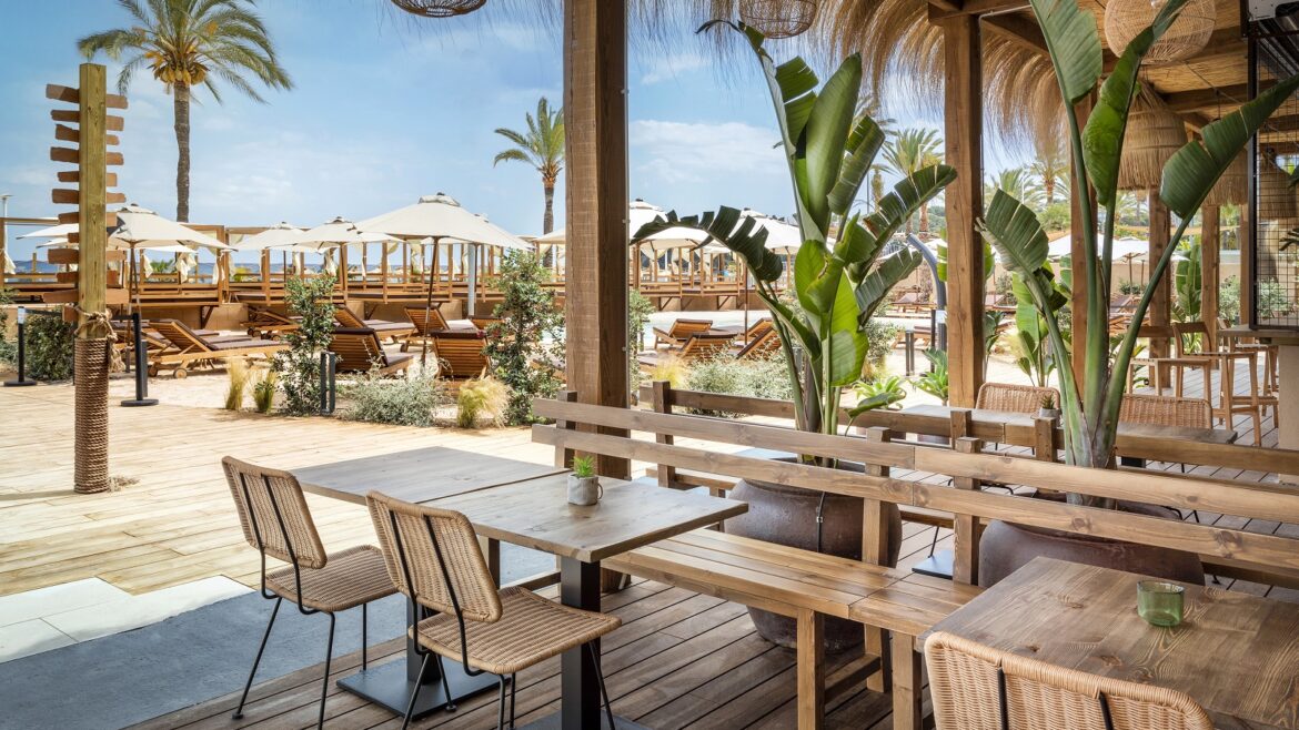 outdoor tables and chairs on the beach at INNSiDE by Meliá Wave Calviá