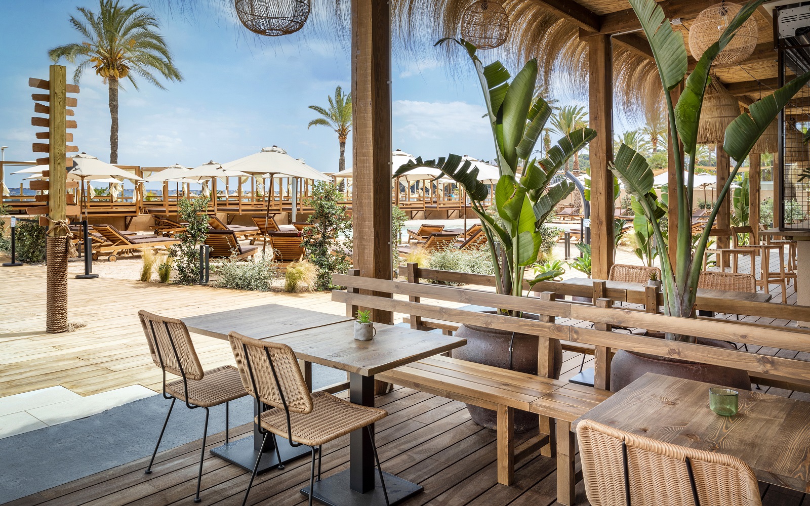 outdoor tables and chairs on the beach at INNSiDE by Meliá Wave Calviá