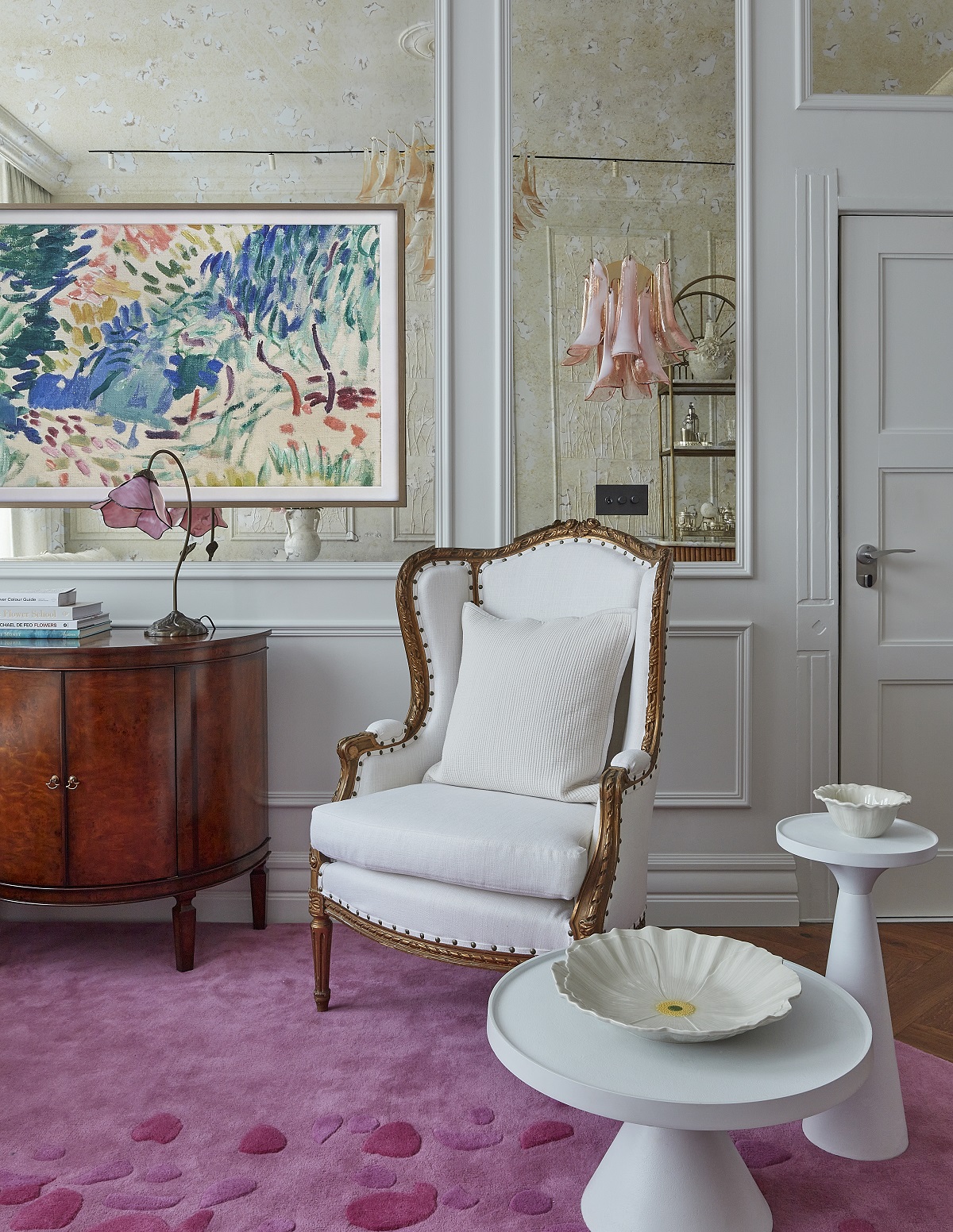 white furniture on a pink carpet with floral decorative accessories