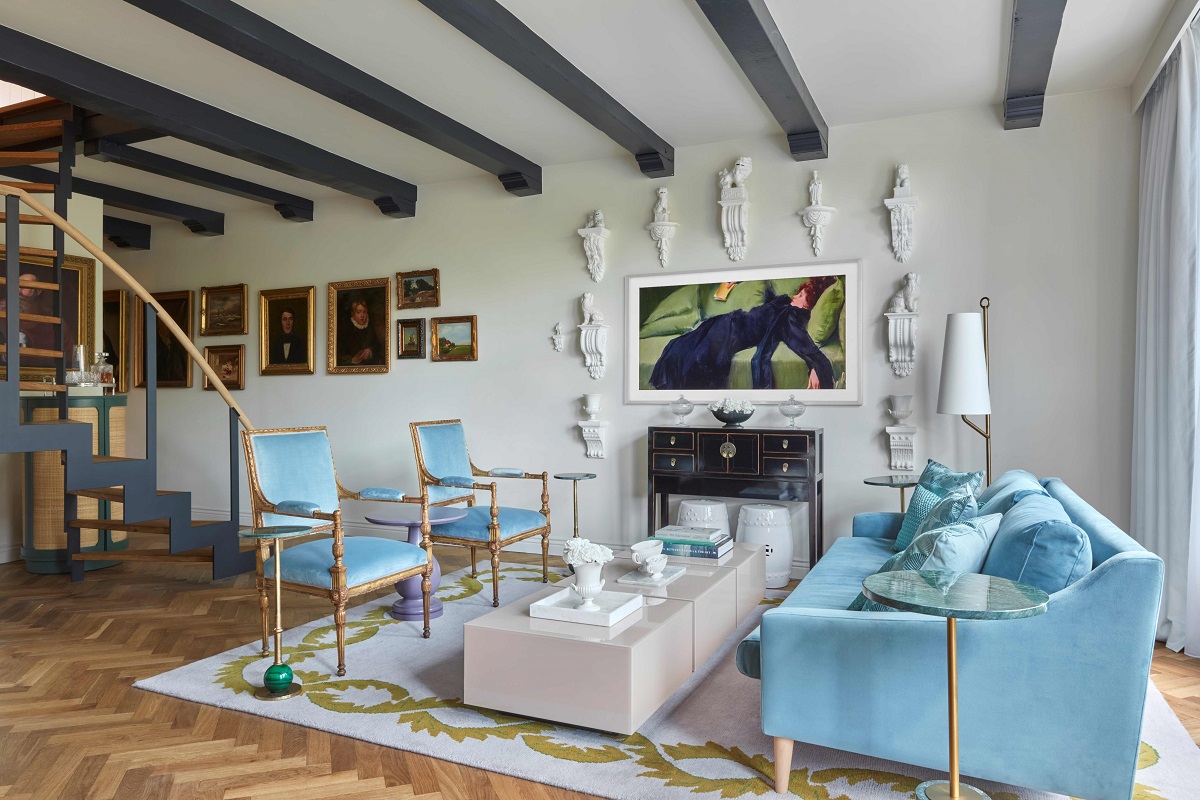 powder blue couch on wooden floor in the Merchant Suite Pulitzer amsterdam