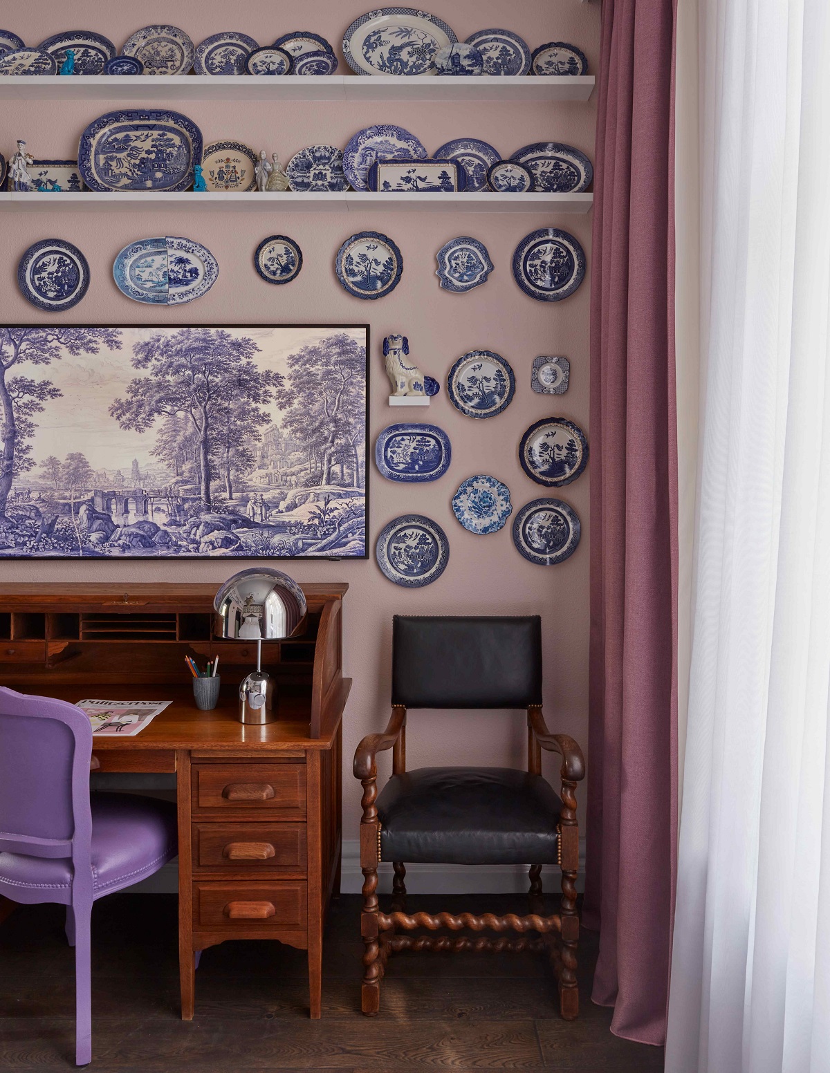 blue chair at wooden desk with blue and white dutch porcelain collection on the wall