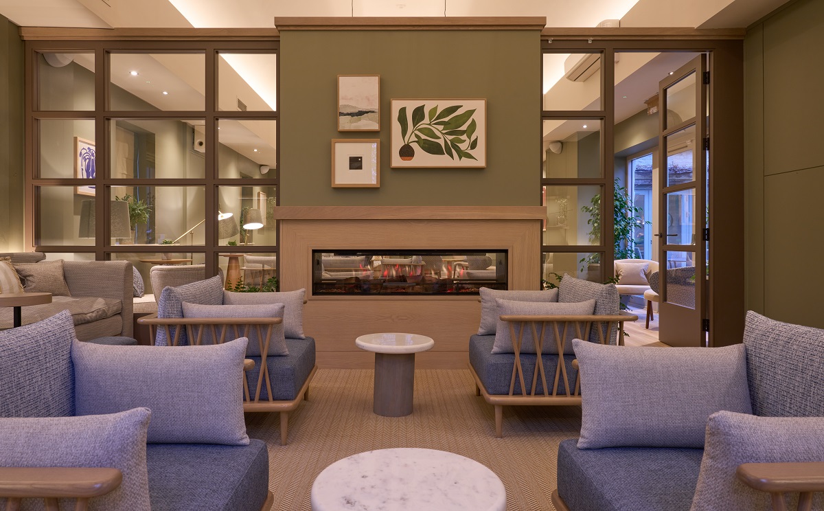 wood, light green and blue details in biophilic room with central fireplace