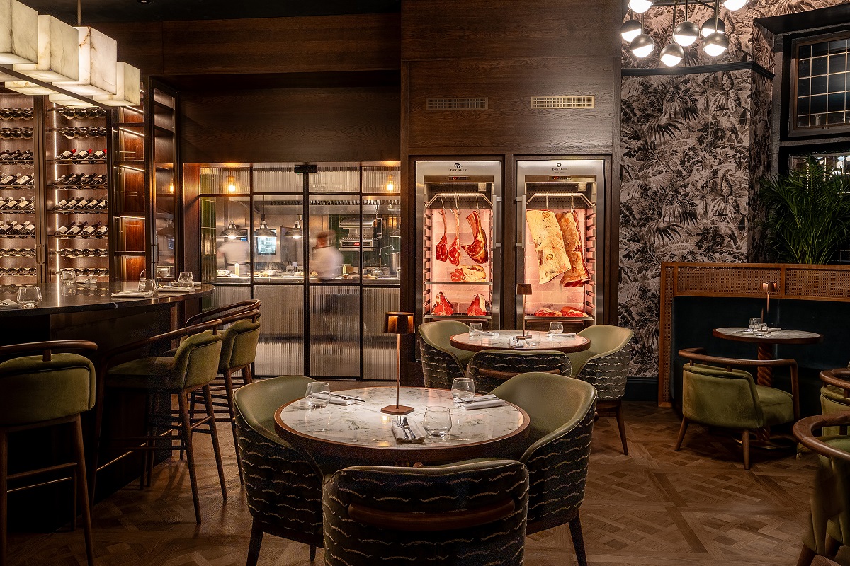 view through to private dining space in restaurant with display fridges and view through to kitchen