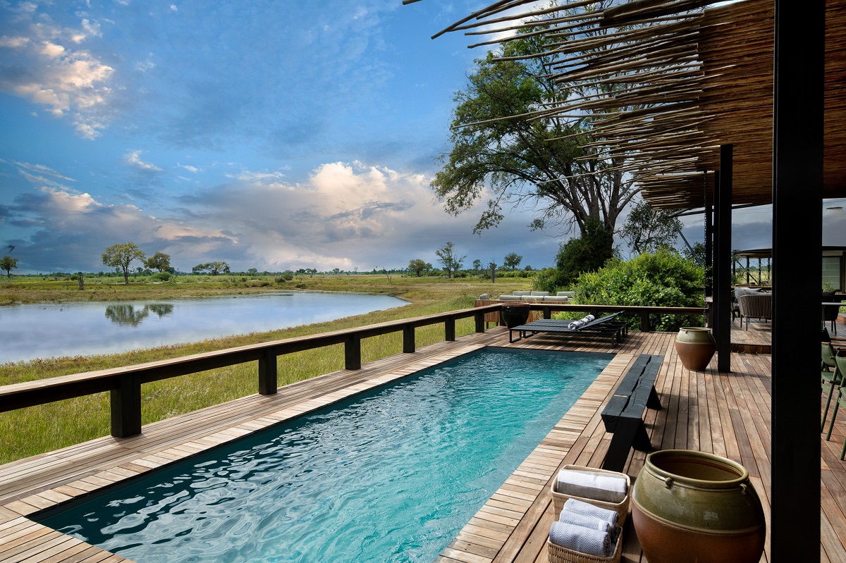 wooden deck and lap pool overlooking animal watering hole at Daunara Camp