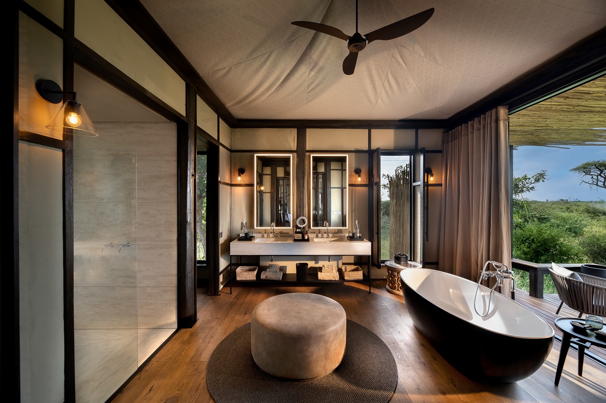 tented bathroom in safari lodge with view to deck and outdoors