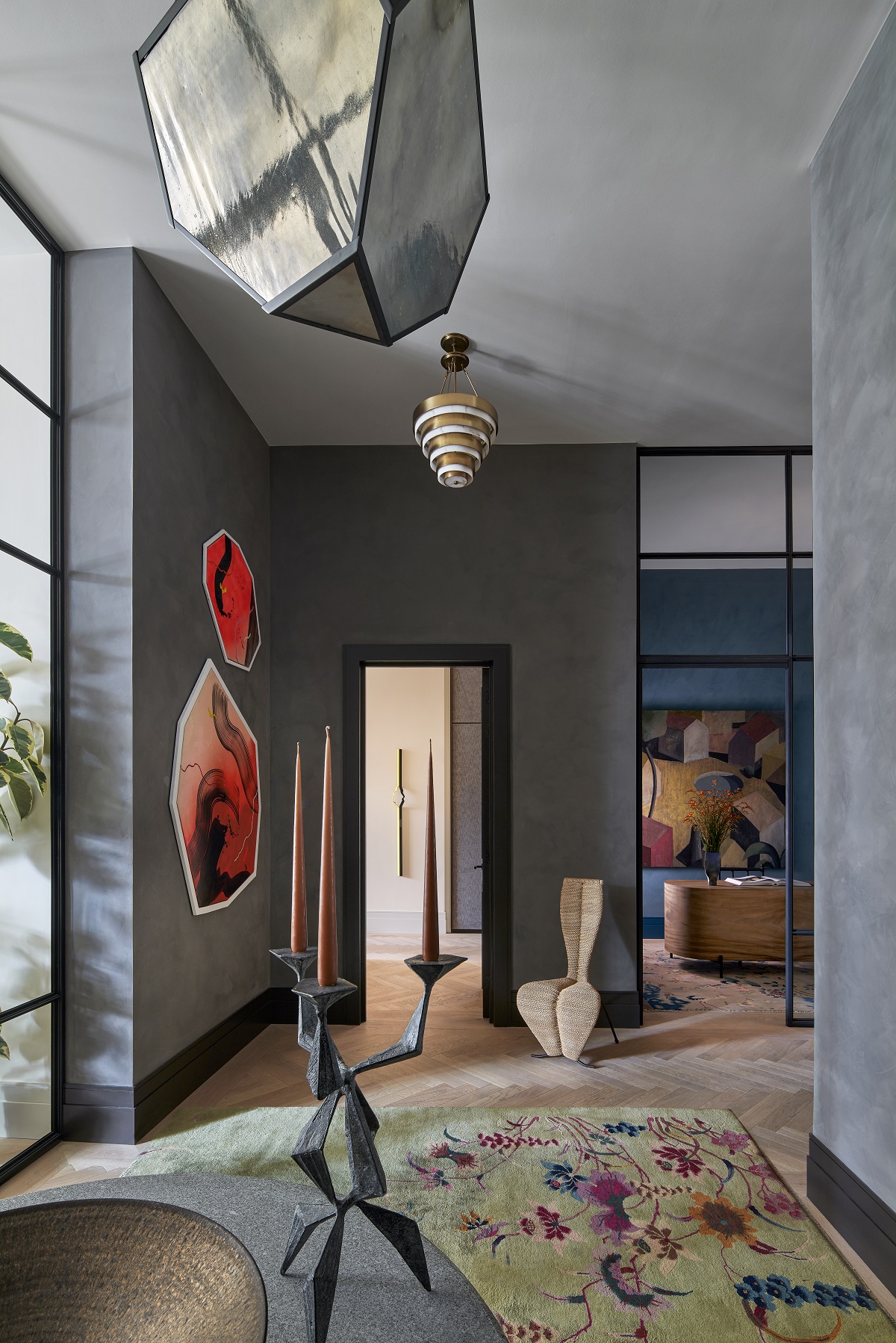 entrance hall with patterned carpet, grey walls and facet shaped art on the wall