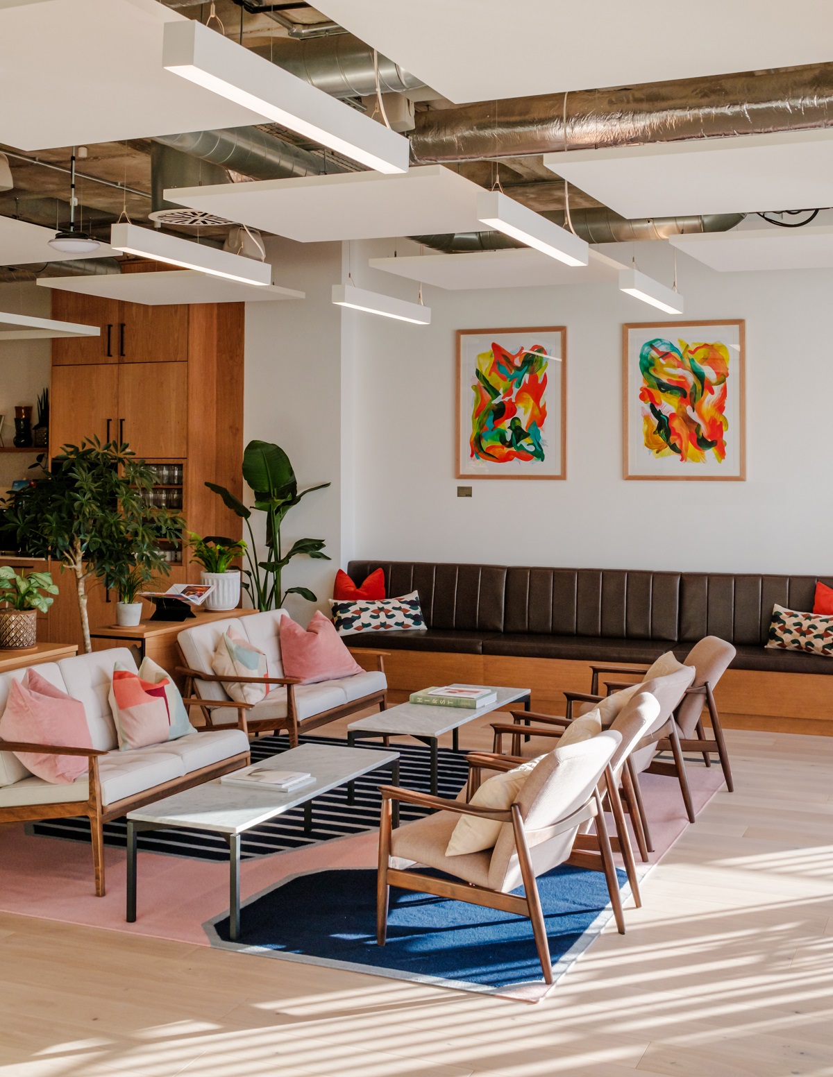 seating and tables in co-working space with bright art on the walls