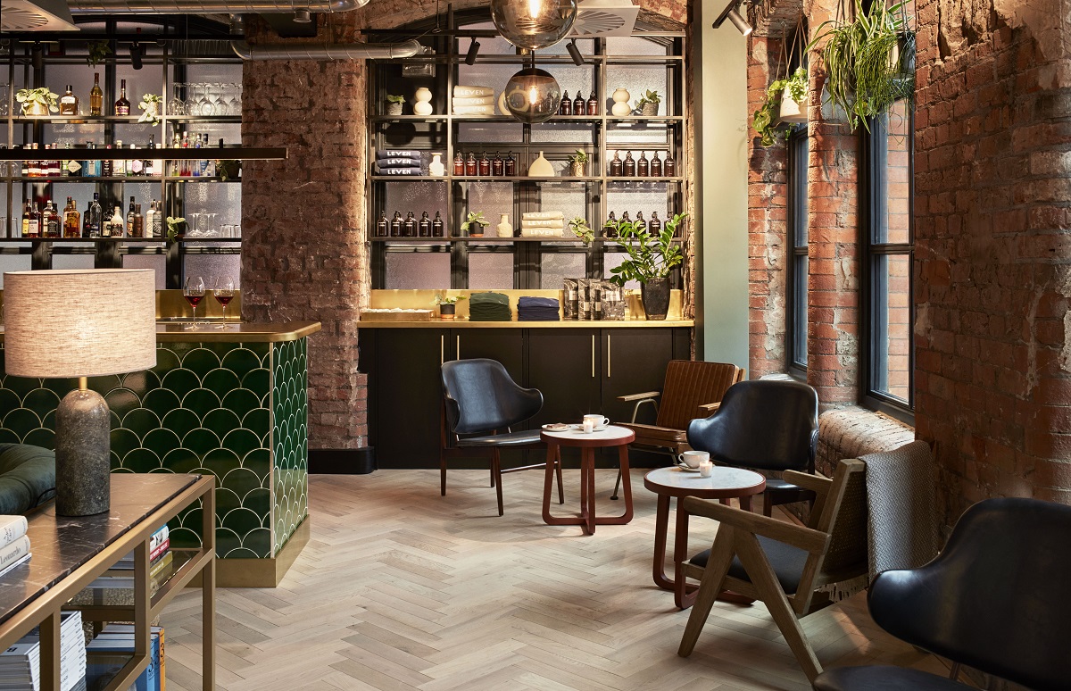 The lobby area at LEVEN Manchester is a cool and contemporary space with cosy seating and a bar area