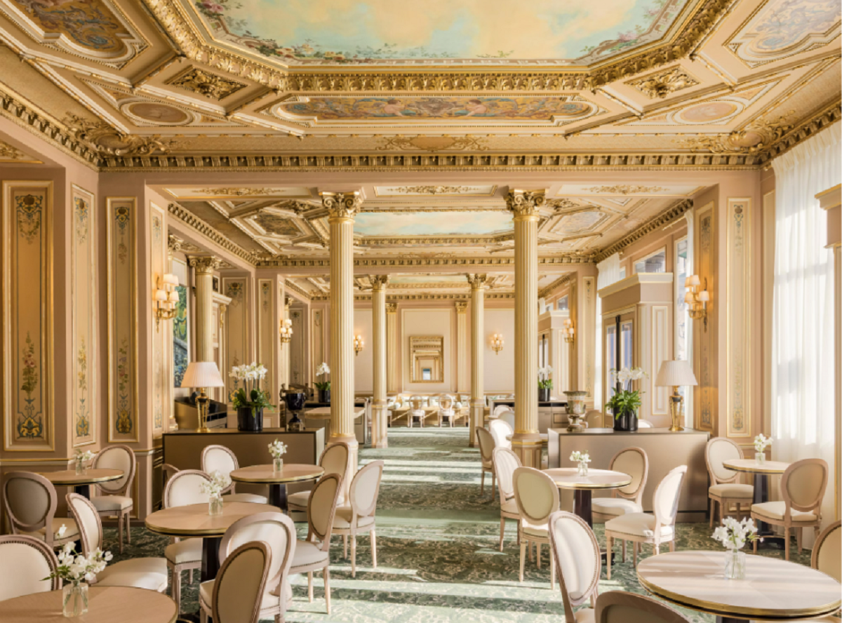 An opulent dining room with painted ceiling and neoclassical styling