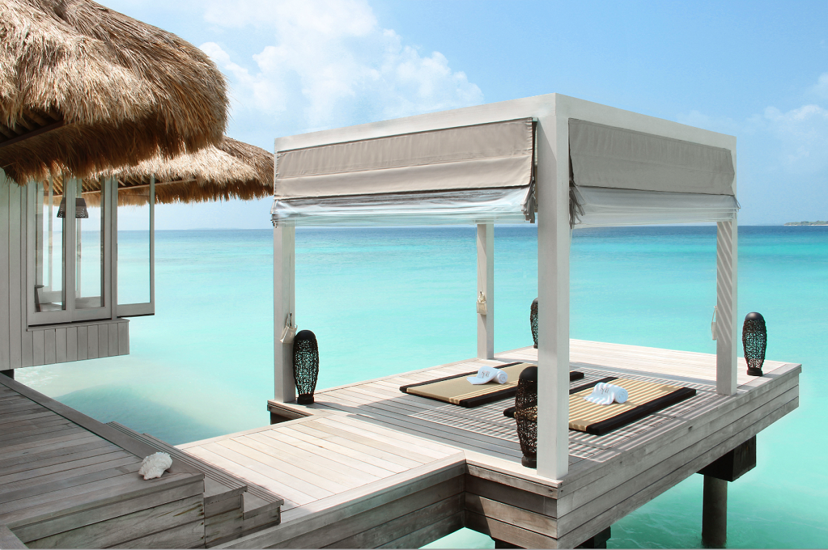 white jetty over blue sea at Cheval Blanc Maldives