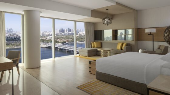 guestroom in The JW Marriott Marquis Hotel with floor to ceiling windows with views over the water and the city