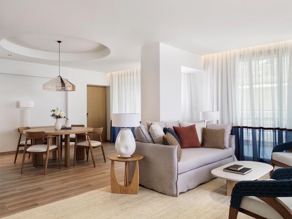 comfortable seating and a dining area in natural shades and textures in hotel suite