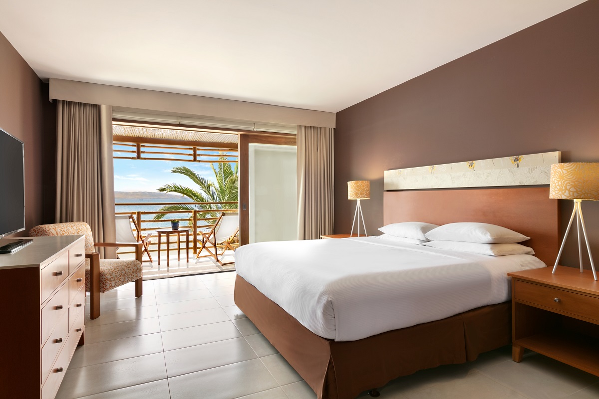 Hyatt resort guest room with doors onto terrace and ocean view