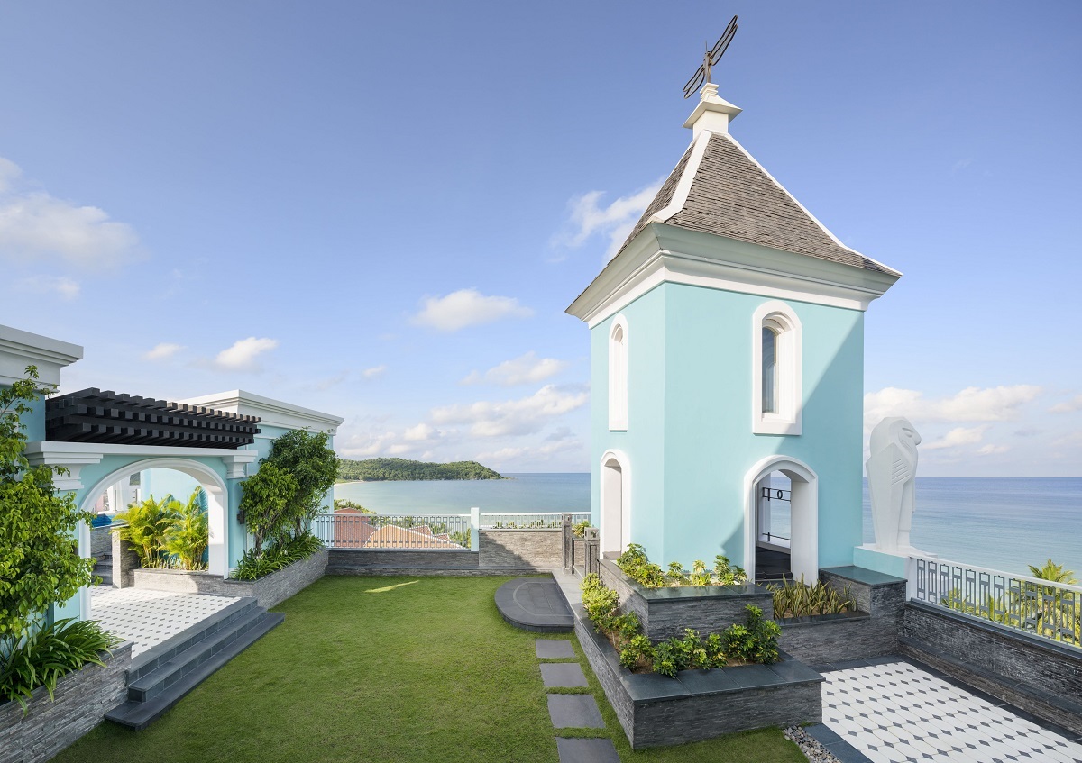 light blue clocktower in garden of hotel suite as a viewing deck for the sea