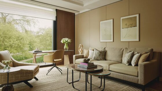 sofa, chair and table in muted natural colours in the balcony suite of The Emory Hotel London