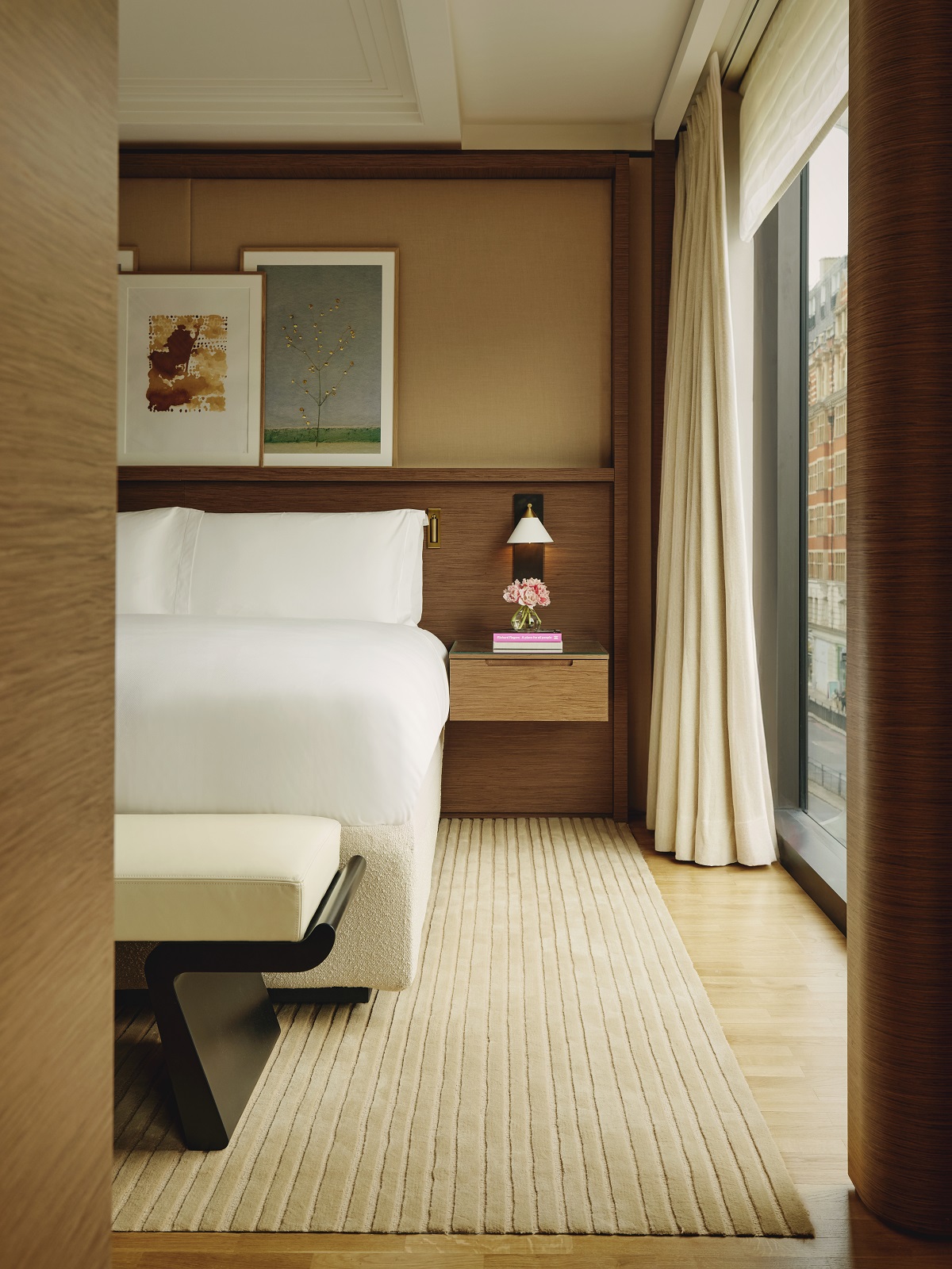 view framed by wooden door frame into the bedroom designed by Pierre-Yves Rochon