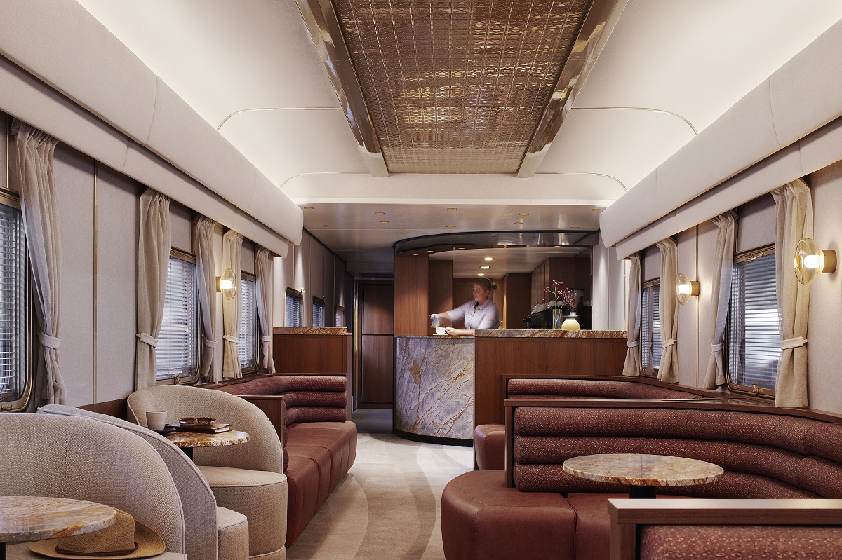 seating in dining area of train with bar and curved lines on carpet