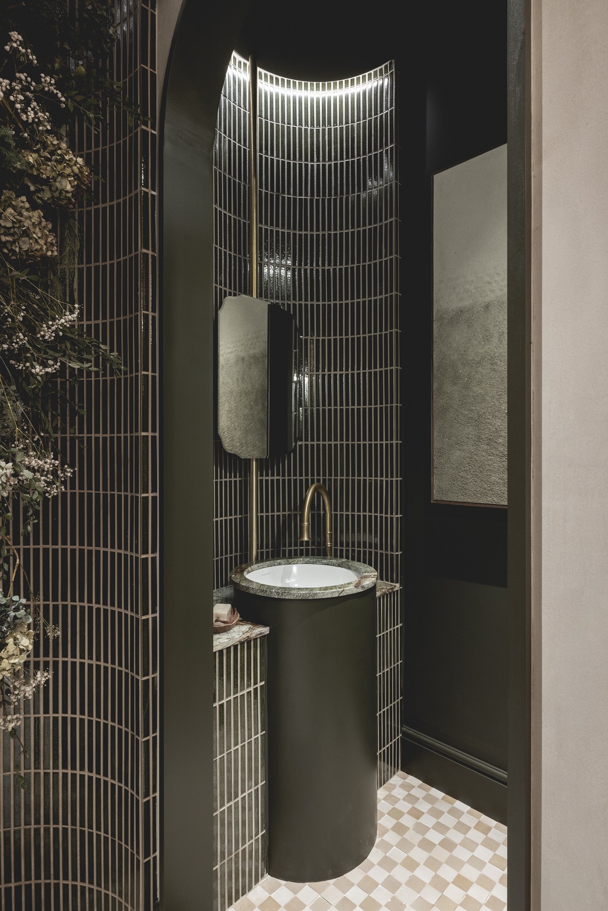 dark green tiles shower walls with basin and cream and white checked floor