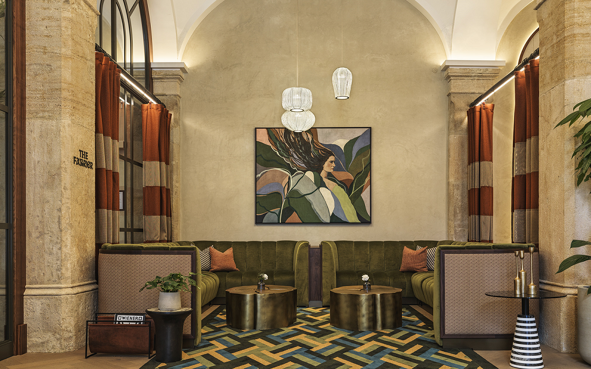 seating alcove in hotel foyer with art on the wall behind banquette Imperial riding School vienna