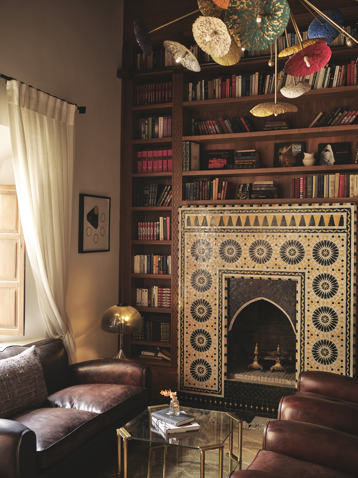 library in IZZA Marrakech with tiled fireplace