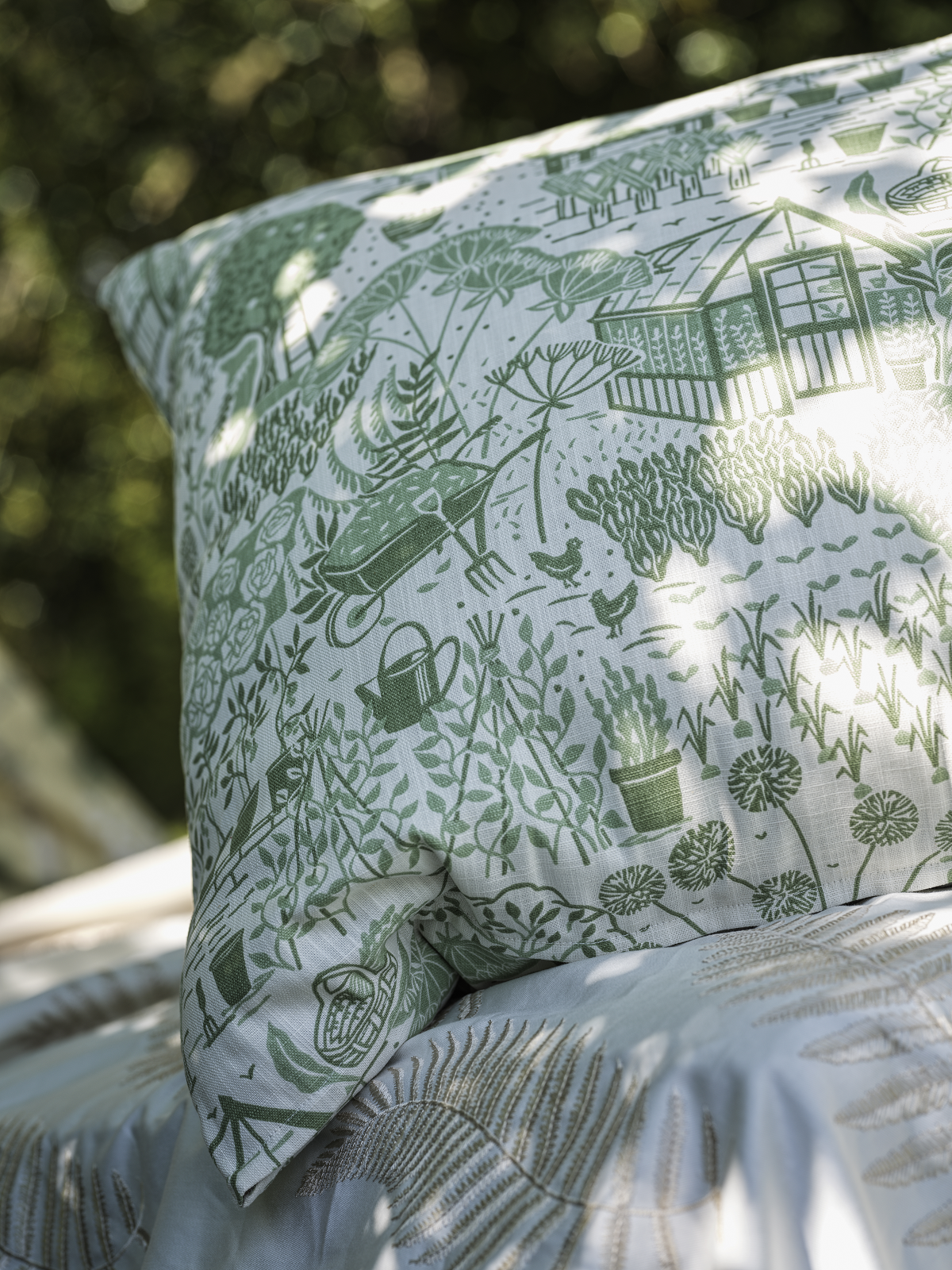 sanderson garden design in green on a white cushion