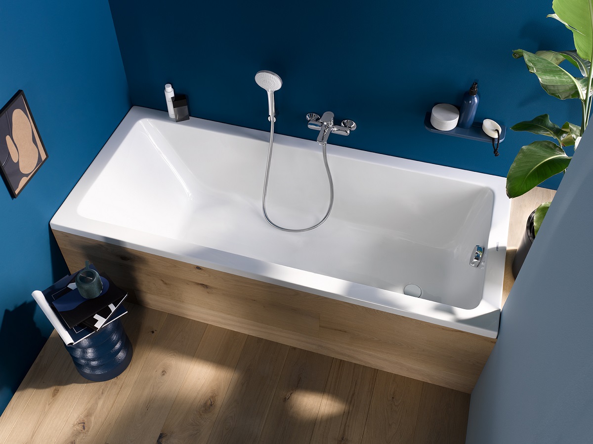 small bath from duravit with wood surround and against blue wall